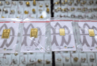 Pedagang mengambil emas batangan PT Antam di toko emas di kawasan Cikini, Jakarta, Rabu (23/4). Foto: Jamal Ramadhan/kumparan