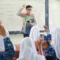 guru yang sedang mengajar di kelas