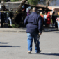 Seorang petugas polisi berjalan di lokasi penembakan di Lwandle, Western Cape, Afrika Selatan, Minggu (27/9/2026). Foto: Esa Alexander/REUTERS